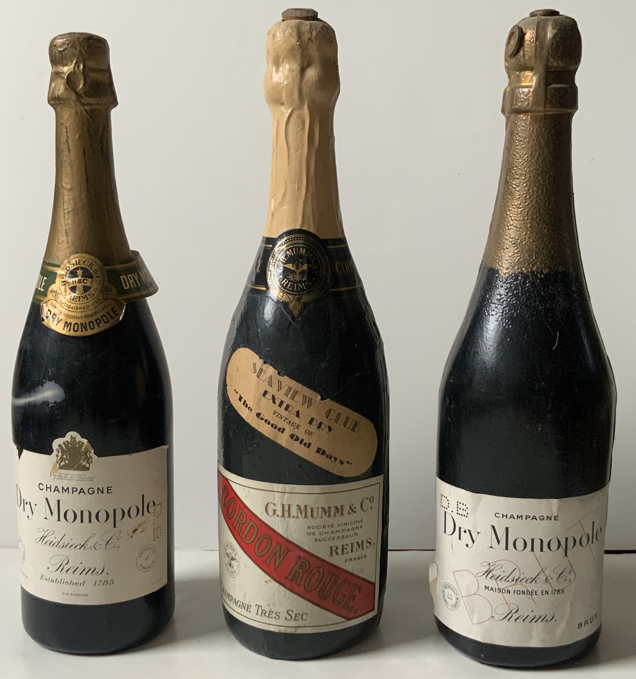 M228	A TRIO OF OLD CHAMPAGNE LITHOGRAPHED PAPER BOARD PARTY BLOWERS